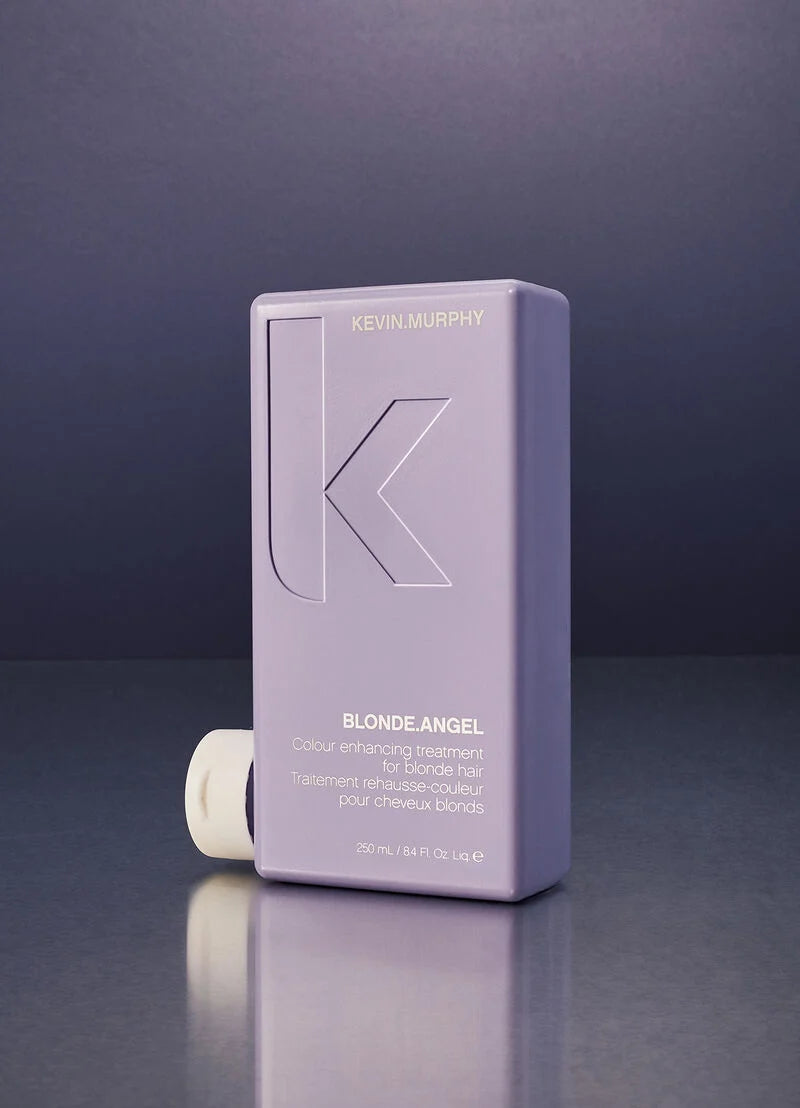 Kevin Murphy Blonde Angel hair color developer bottle in a lavender purple color, shown with its white cap off on a dark reflective surface.