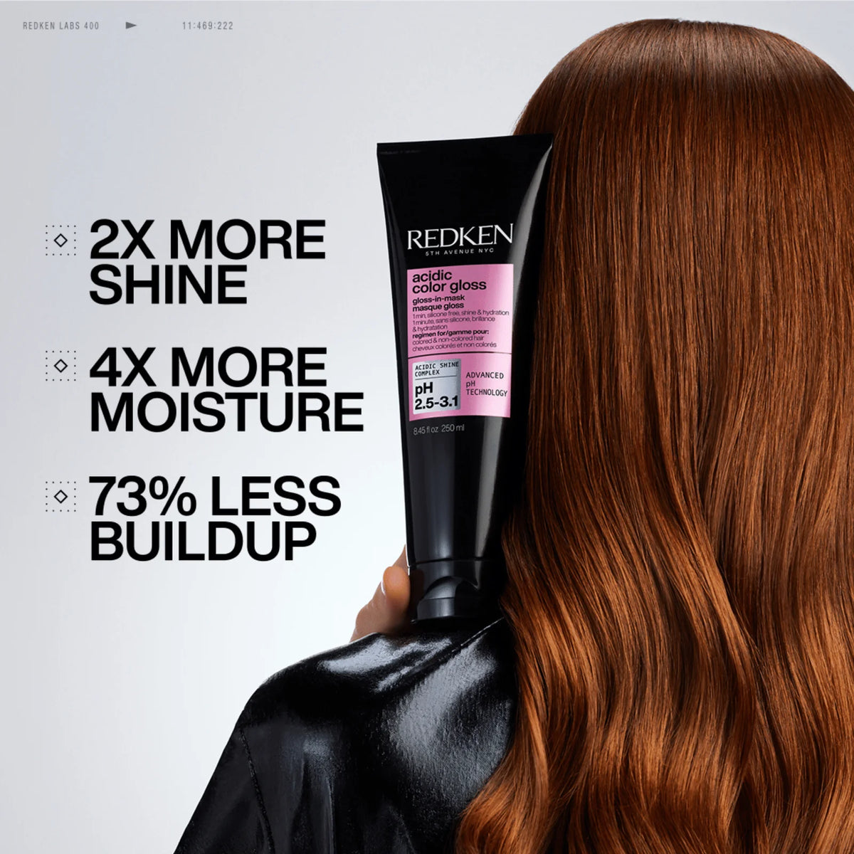 Redken hair care product with a woman holding it, showing text about hair benefits.