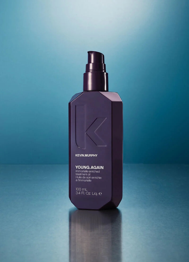 A 300 mL bottle of Kevin Murphy Young Again hair product, featuring a dark purple faceted design and a black pump dispenser, set against a blue gradient background with a soft reflection below.