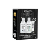 Redken Acidic Bonding Concentrate gift set in a black box, featuring three white bottles and a white tube of hair repair products.