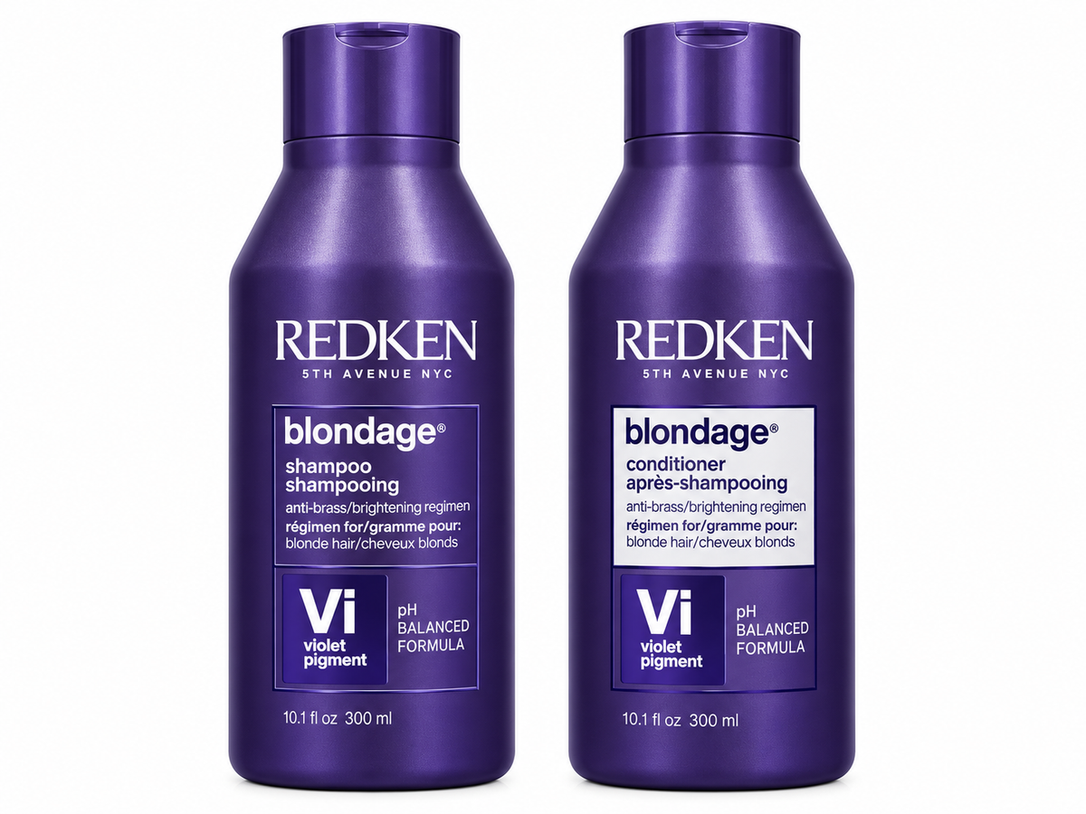 Two Redken Blondage hair care bottles on a white background: a violet pigment shampoo and a matching conditioner. Both bottles are dark purple with white and light purple labeling.