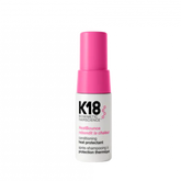 K18 hair care product bottle with pink cap on a white background