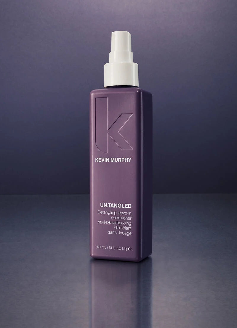 Kevin Murphy Untangled Detangling Leave-in Conditioner in a rectangular purple bottle with a white spray top, set against a dark purple gradient background.
