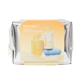 DesignMe Curl Kit in a metallic silver zippered pouch with a large yellow-orange label showing the included bottles and a blue curling tool, on a white background.
