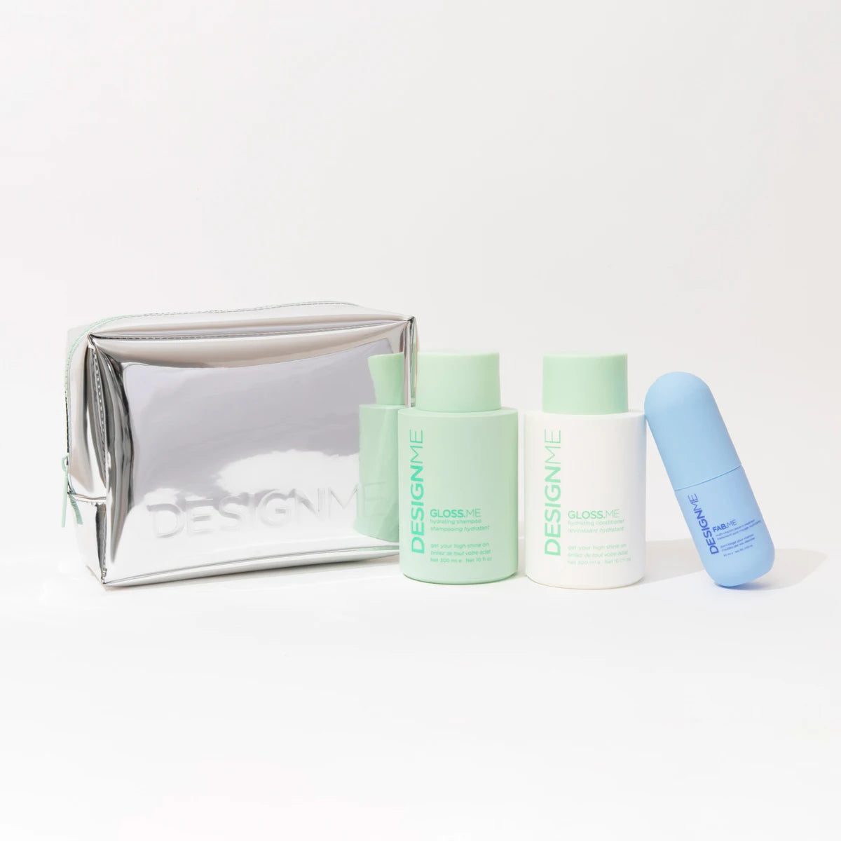 A skincare set from DESIGN+HE on a clean white background, featuring a metallic silver zippered pouch, a mint green bottle labeled GLOBER-IE, a white bottle labeled SCORP-IE, and a light blue bottle.