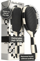 Detangler hair brush with packaging displaying text about its use on wet or dry hair.