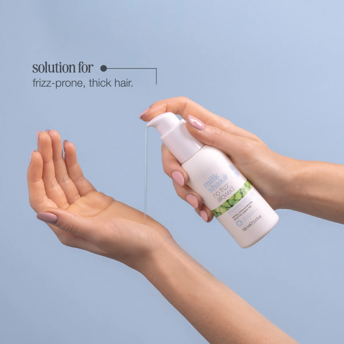 Person holding a bottle of hair product with text on a light blue background