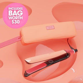 Hair straightener with carrying case on a pink background
