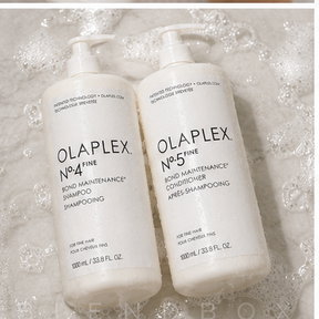 Two white Olaplex bond care bottles, No.4 Fine Bond Maintenance Shampoo and No.