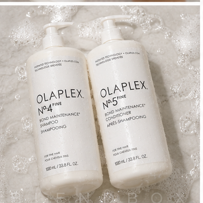 Two white Olaplex bond care bottles, No.4 Fine Bond Maintenance Shampoo and No.