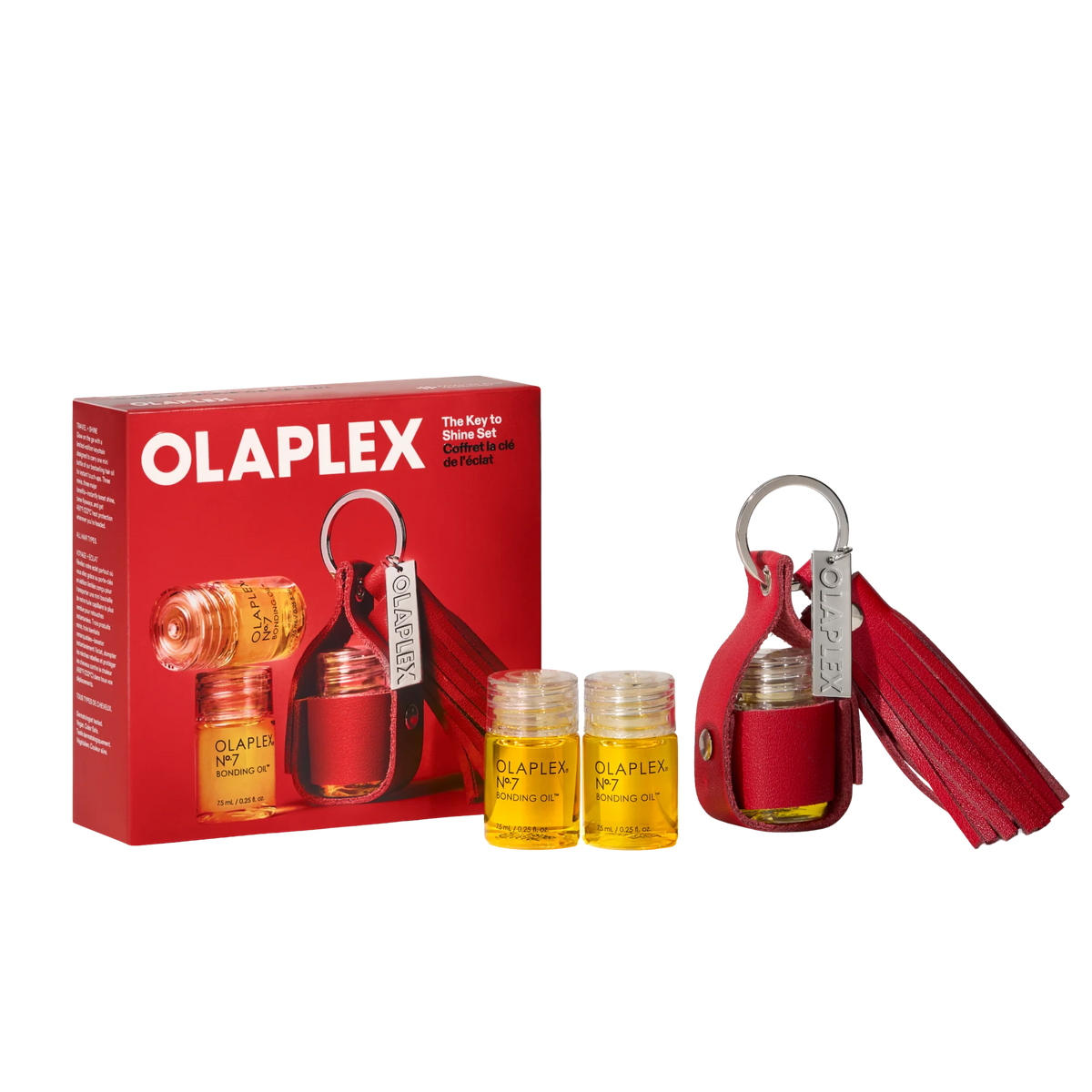 Olaplex The Key to Shine Set, featuring a red leather key case with a tassel, two small clear bottles of yellow oil, and the red retail box on a white background.