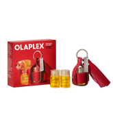 Olaplex The Key to Shine Set, featuring a red leather key case with a tassel, two small clear bottles of yellow oil, and the red retail box on a white background.