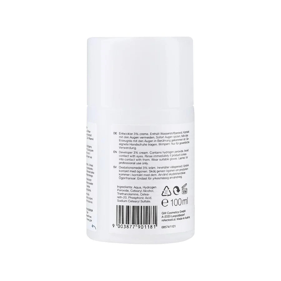 A white cylindrical cosmetic bottle with a ribbed cap, showing the back side with printed text, a barcode, and recycling symbols on a plain white background.
