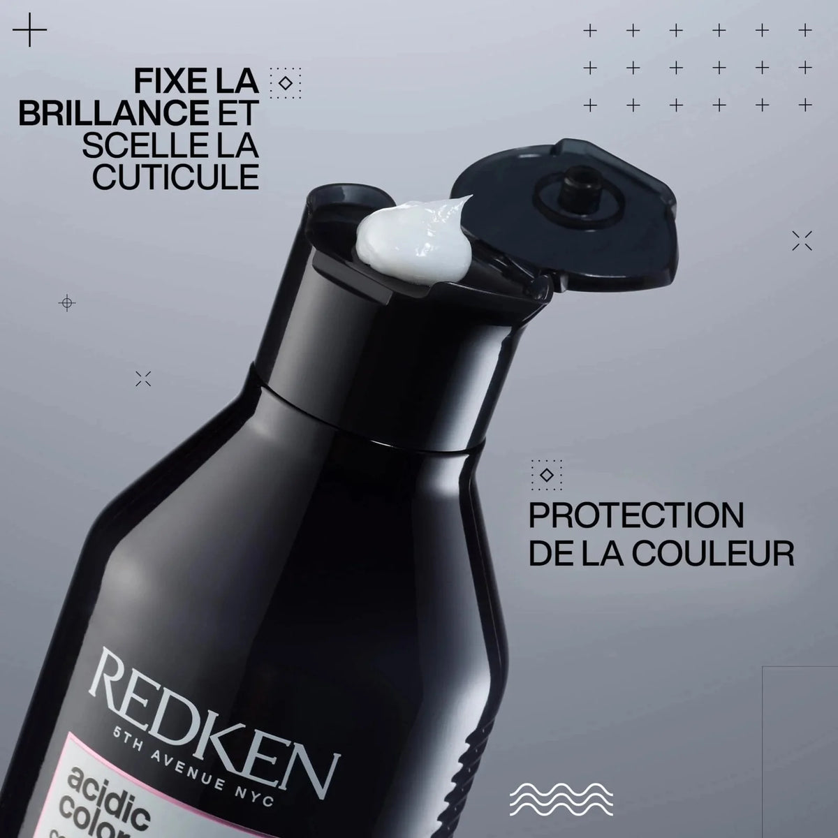Redken hair care product with text on a gray background