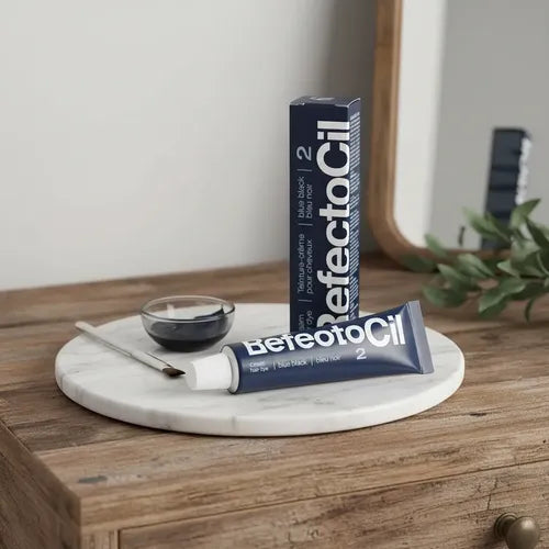 BeteotoCil 2 Deep Root touch-up hair dye in a navy blue tube and matching box, styled on a round white marble tray with a small glass bowl, brush, and applicator on a wooden table.