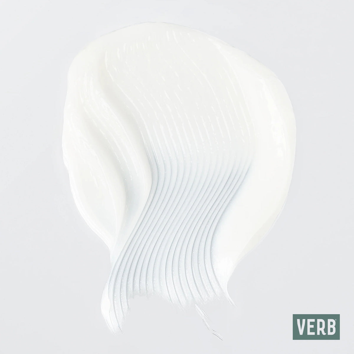 A thick, creamy white cosmetic or skincare product swatch with a smooth, swirled texture on a light gray background, featuring a green 'VERB' brand logo in the bottom right corner.